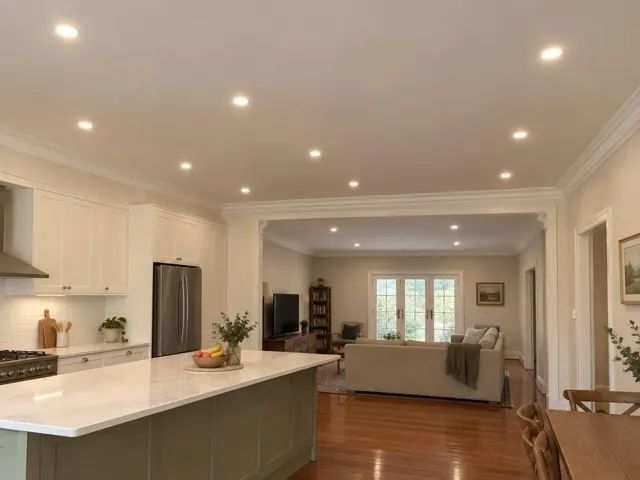 Recessed LED downlights in open-plan kitchen and living room with polished floors in Asquith